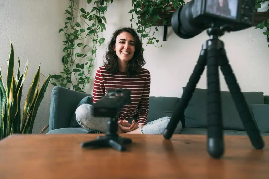 Girl recording herself laughing at camera. Selective focus. Vlogging concept