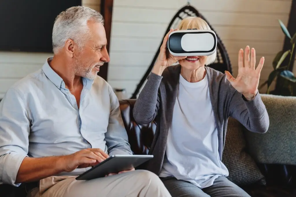 old-elderly-retired-woman-using-vr-virtual-reality-headset-in-apartment-.jpg