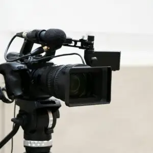 professional digital video or movie camera with microphone on tripod