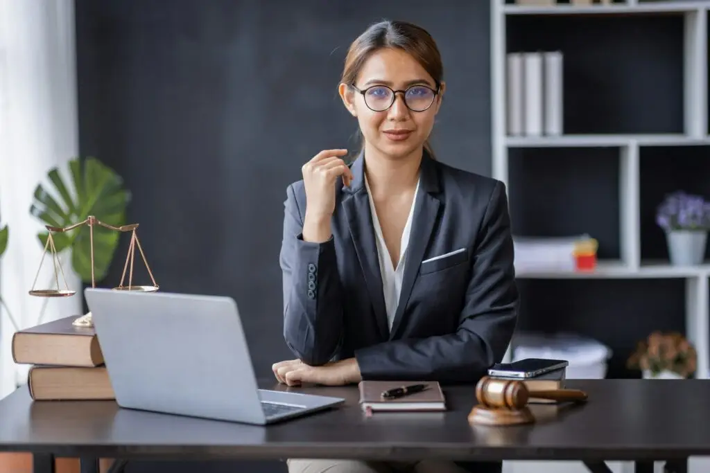 Attractive lawyer in office Business woman and lawyers discussing contract papers with brass scale o