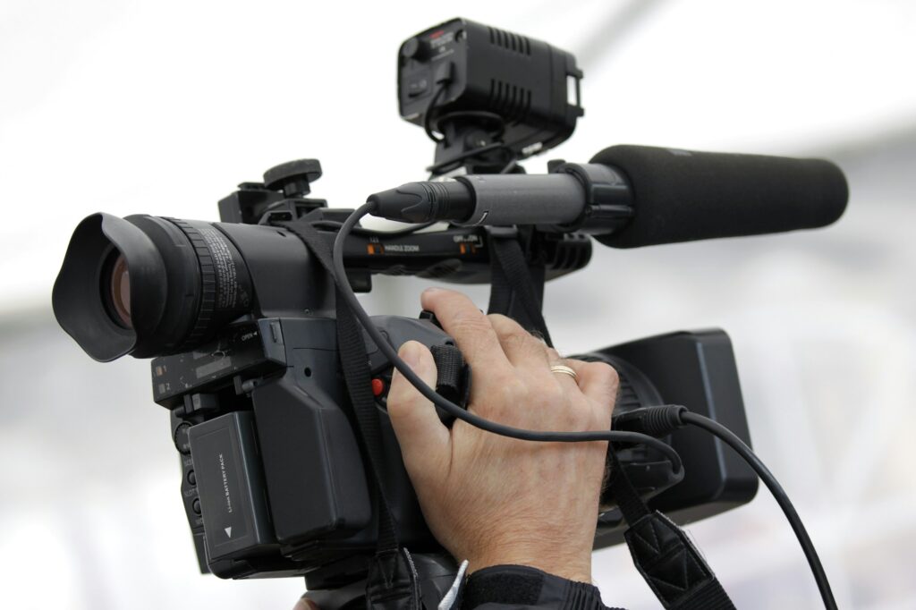 Hand of the cameraman holding video camera